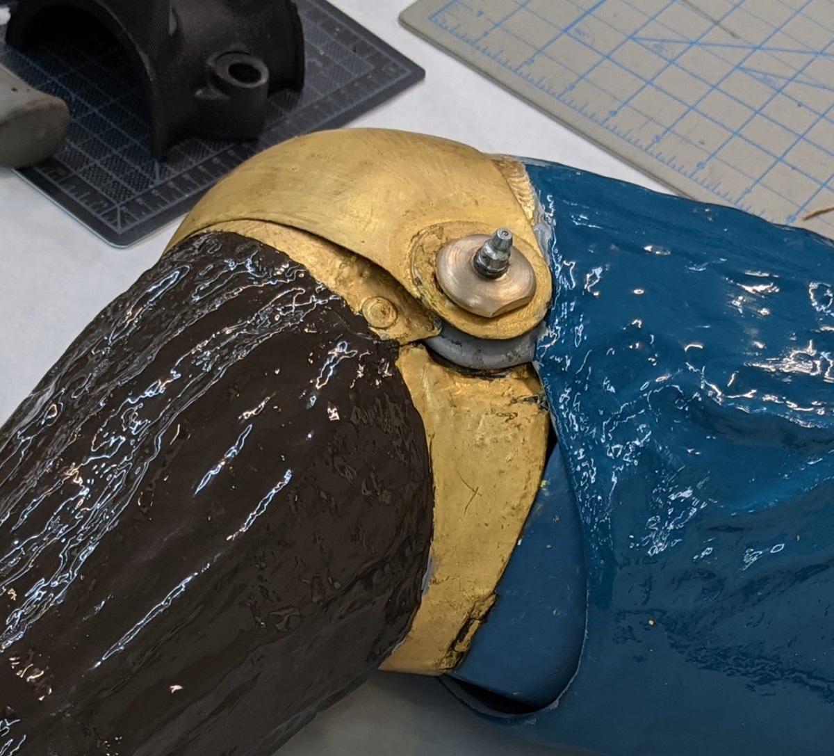 Elbow joint Painted and gold tubular shape with hinged bend in middle