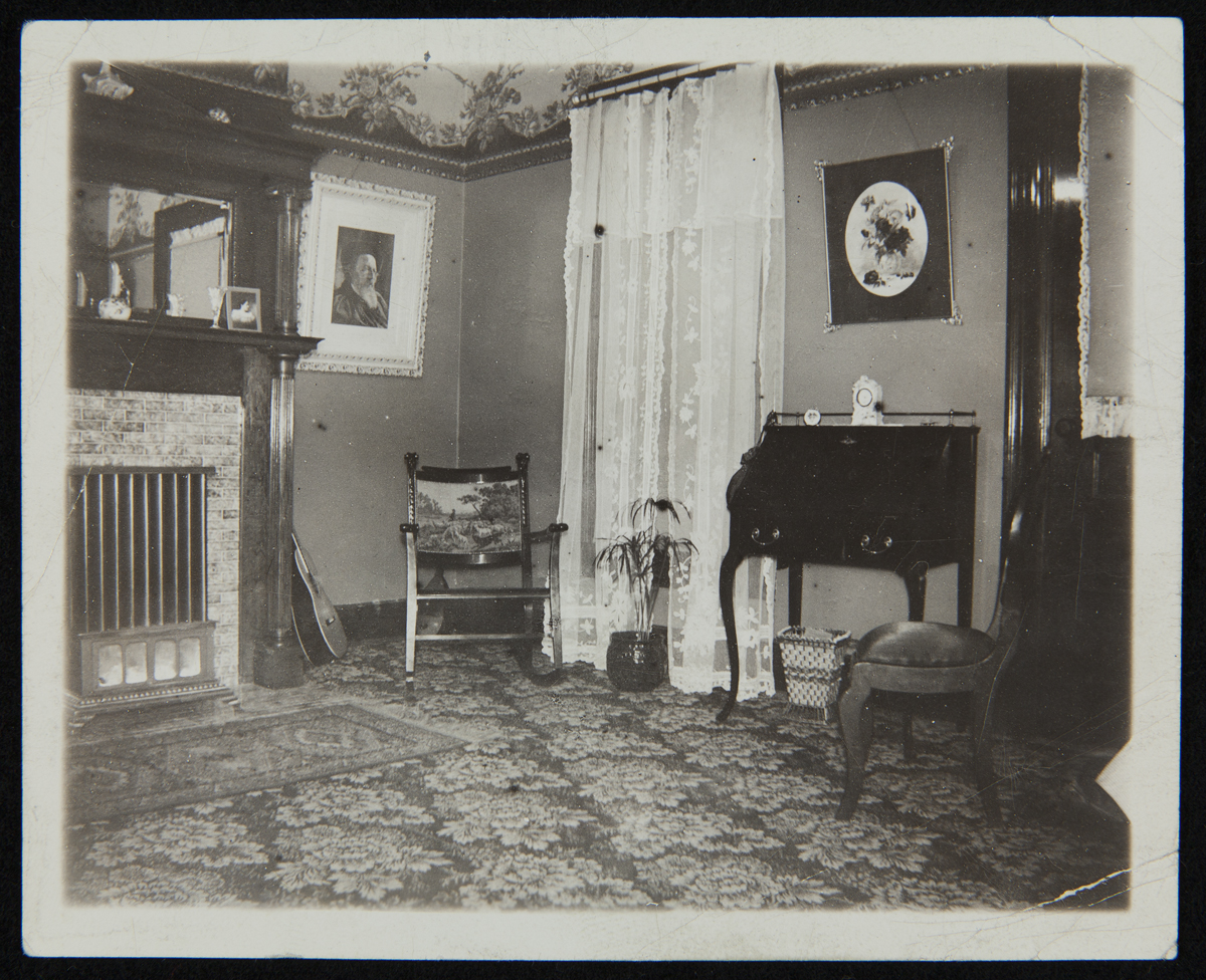 Room with chairs, window, desk, elaborate fireplace