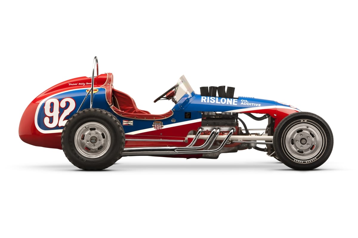 1958 Moore/Unser Pikes Peak Hill Climb Racing Car Side view of red, blue, and white open cockpit race car with large "92" and other text on side