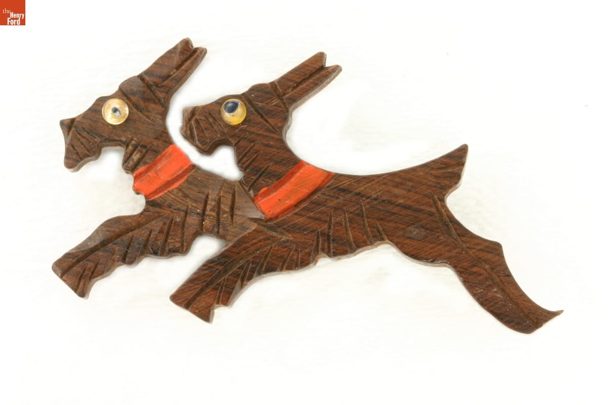 'Scottie' (Scottish Terrier) Pin, circa 1940 Brown wooden pin carved to depict two Scottie dogs wearing red collars running