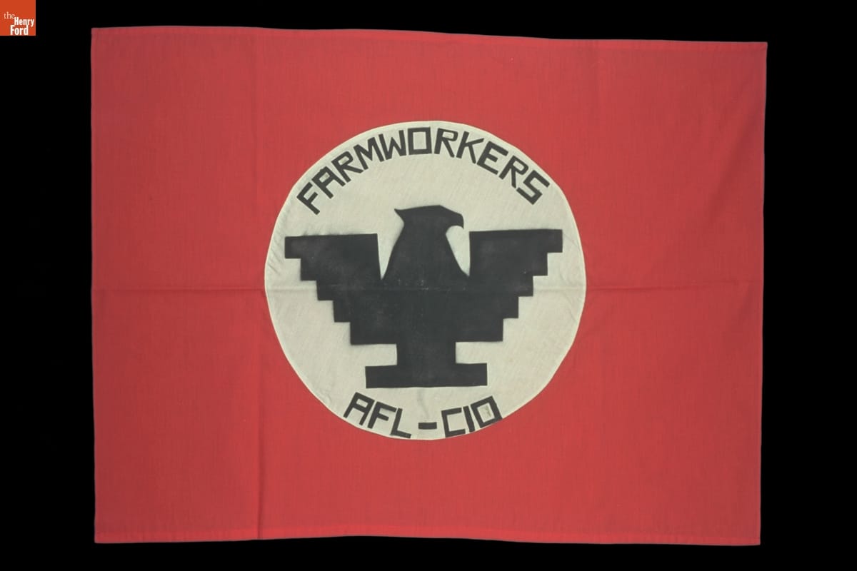 United Farm Workers Flag, circa 1970 Red flag with white circle containing stylistic, blocky silhouette of eagle and text "FARMWORKERS AFL-CIO"