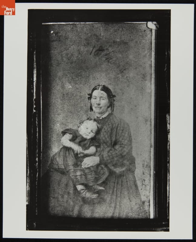 Cynthia Coryell Howard Holding Her Daughter, Letitia, 1865-1866 Framed portrait of woman in dress with hair in two long coils on either side of her face, holding a young child