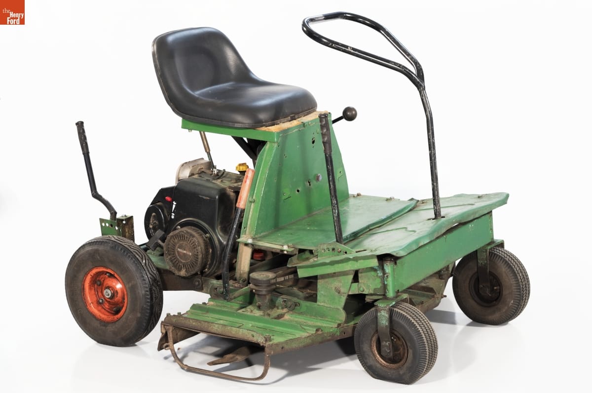 Bradley Riding Lawn Mower, 1958-1960 Minimal riding lawnmower, with open green base topped with black seat with machinery underneath
