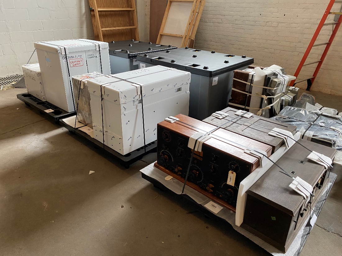 Packed collections ready to move Boxes and objects strapped onto pallets