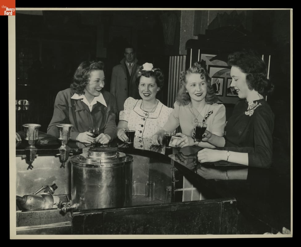 Women at Lunch Counter, Willow Run Bomber Plant, 1943 Four women with beverages sit at a counter