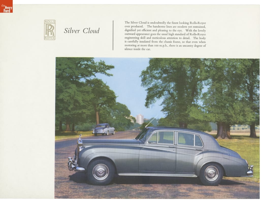 Rolls-Royce Silver Cloud II Sales Catalog, circa 1960 Silver limousine with long hood parked crossways on driveway with grass, trees, buildings in the vicinity