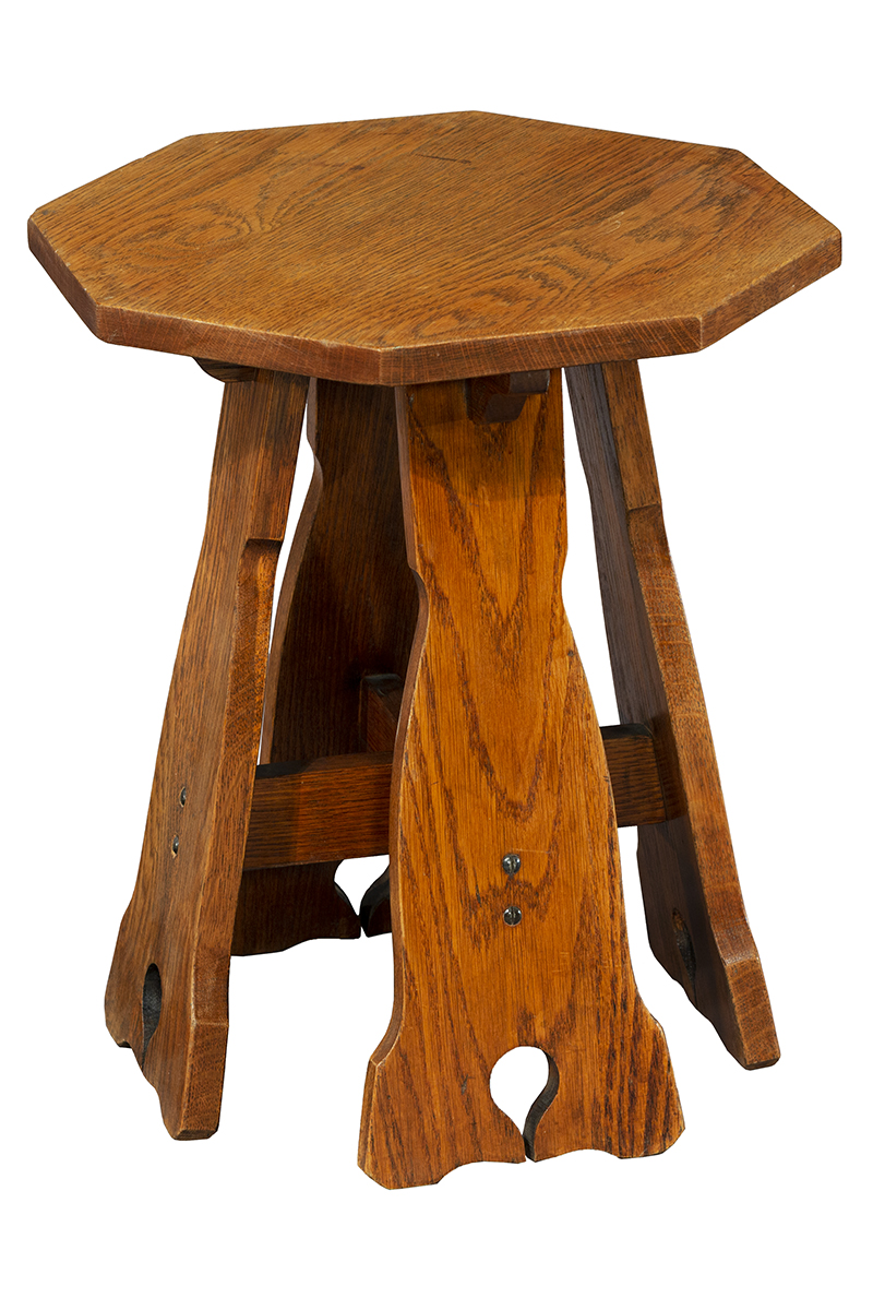 Small wooden table or stool with four wide, uniquely shaped legs and octagonal top