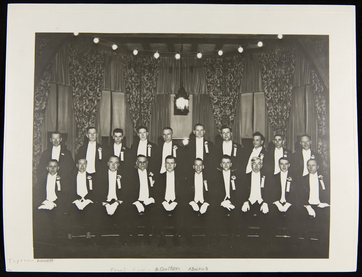 Light's Golden Jubilee Ushers, October 21, 1929 Men in tuxedos and white gloves pose for a photo, some standing and some sitting
