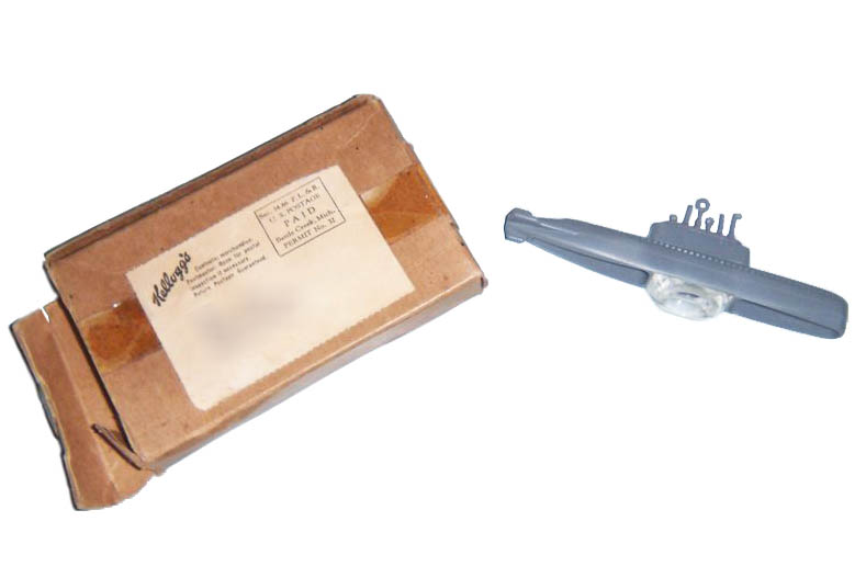 Toy Submarine, 1954 Gray plastic toy submarine, 1954, along with brown cardboard box with mailing label showing Kellogg’s as sender
