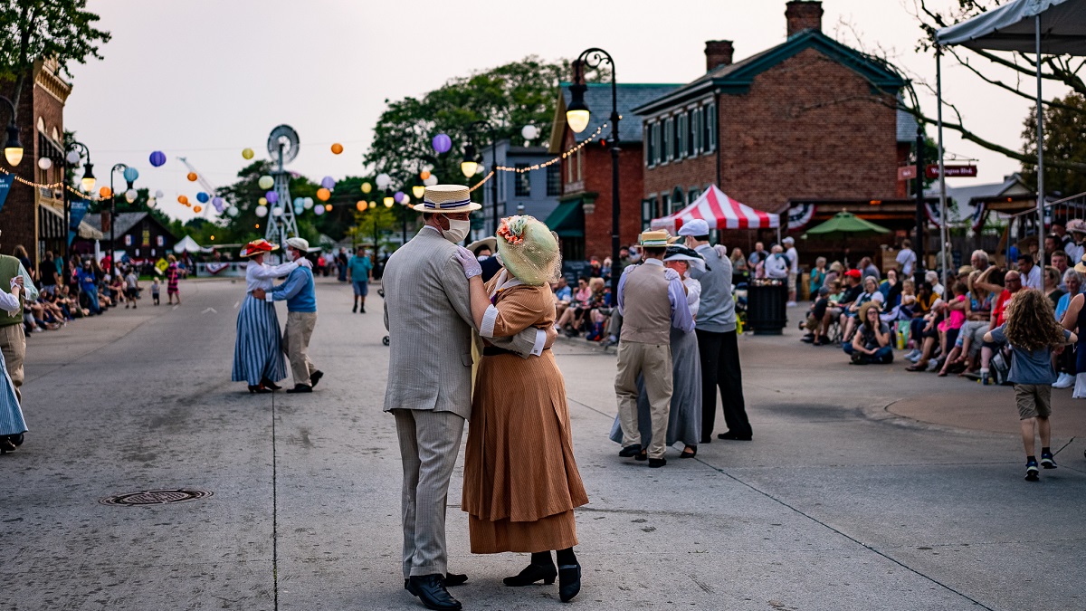 Dancing at Old Car Festival 2021 People wearing historical clothing dance in couples in a street as people look on from the sidelines