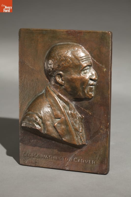 George Washington Carver Plaque, 1945 Bronze-colored metal plaque with raised portrait of man's head and shoulders