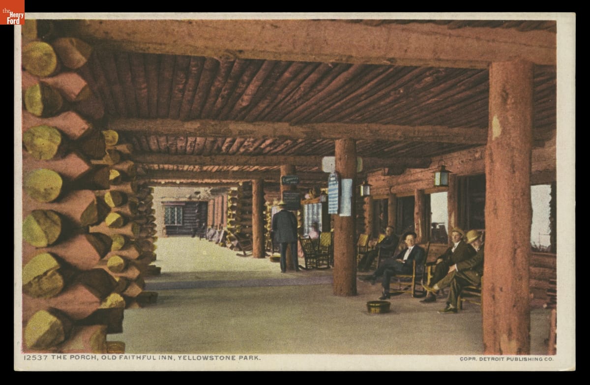 The Porch, Old Faithful Inn, Yellowstone Park, 1908-1909 Postcard of large covered porch created from logs; people sit in rocking chairs beneath it