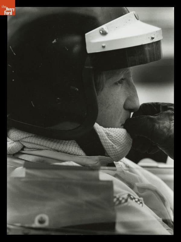 Racing Driver Jochen Rindt at Canadian Grand Prix, Mosport International Raceway, August 1969 Close-up side view of man's head in crash helmet with a gloved hand to his mouth