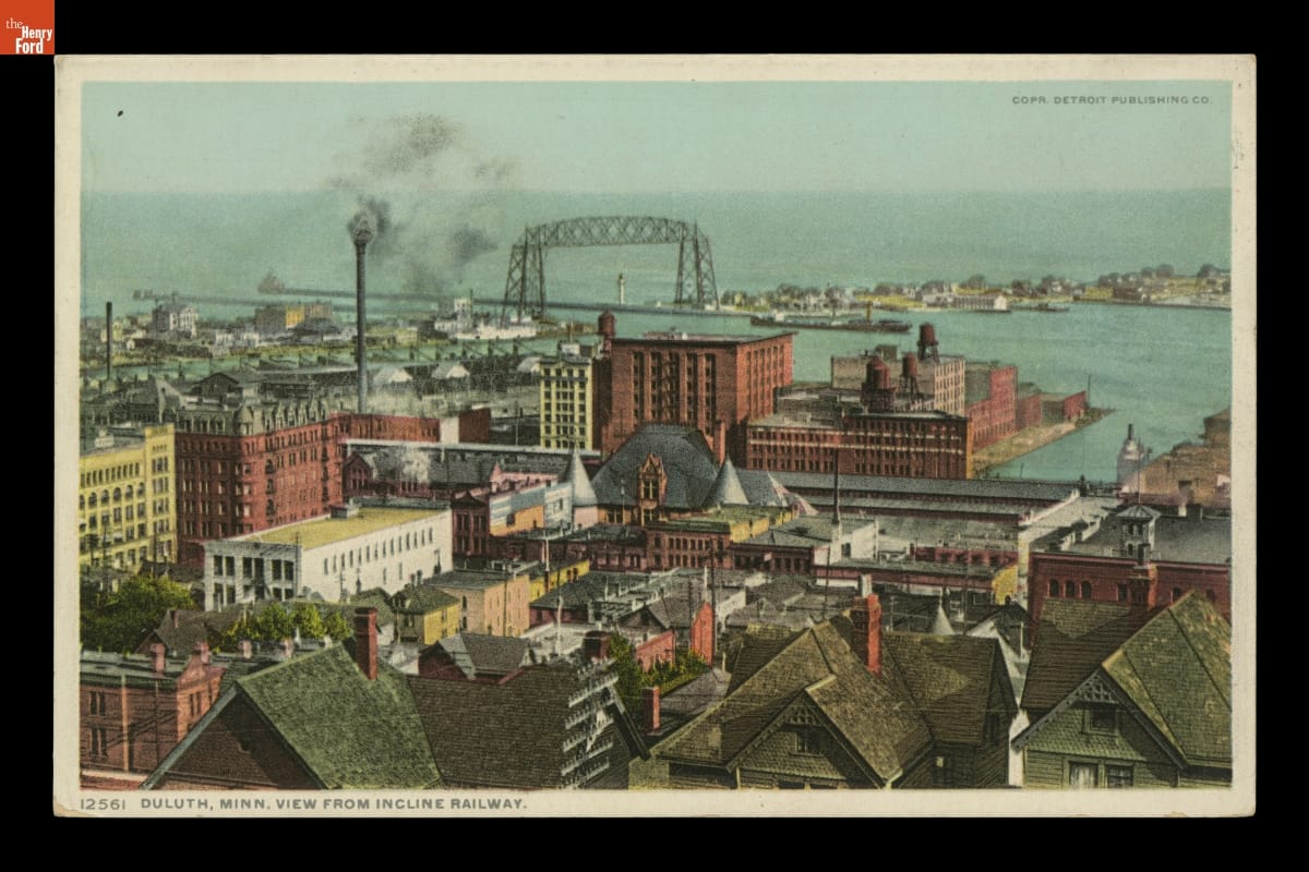 View from Incline Railway, Duluth, Minnesota, circa 1908 Aerial view of what appear to be houses, offices, and industrial buildings near a body of water, with smoke billowing from a smokestack