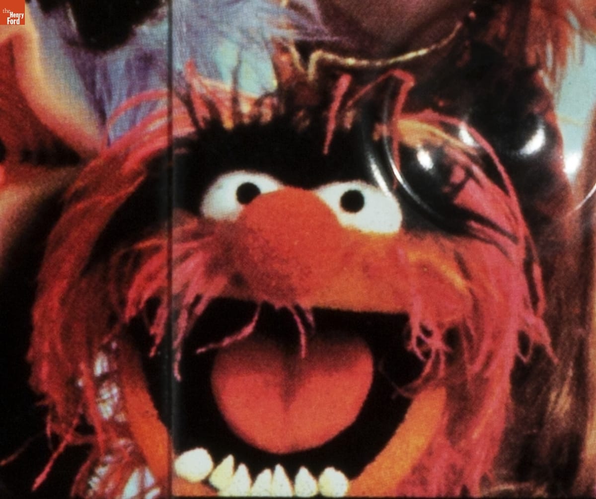 "Jim Henson's Muppets" Lunchbox, 1979 / Animal detail Puppet face with wispy red hair and mustache, bushy black eyebrows, round red nose, and pointy lower teeth