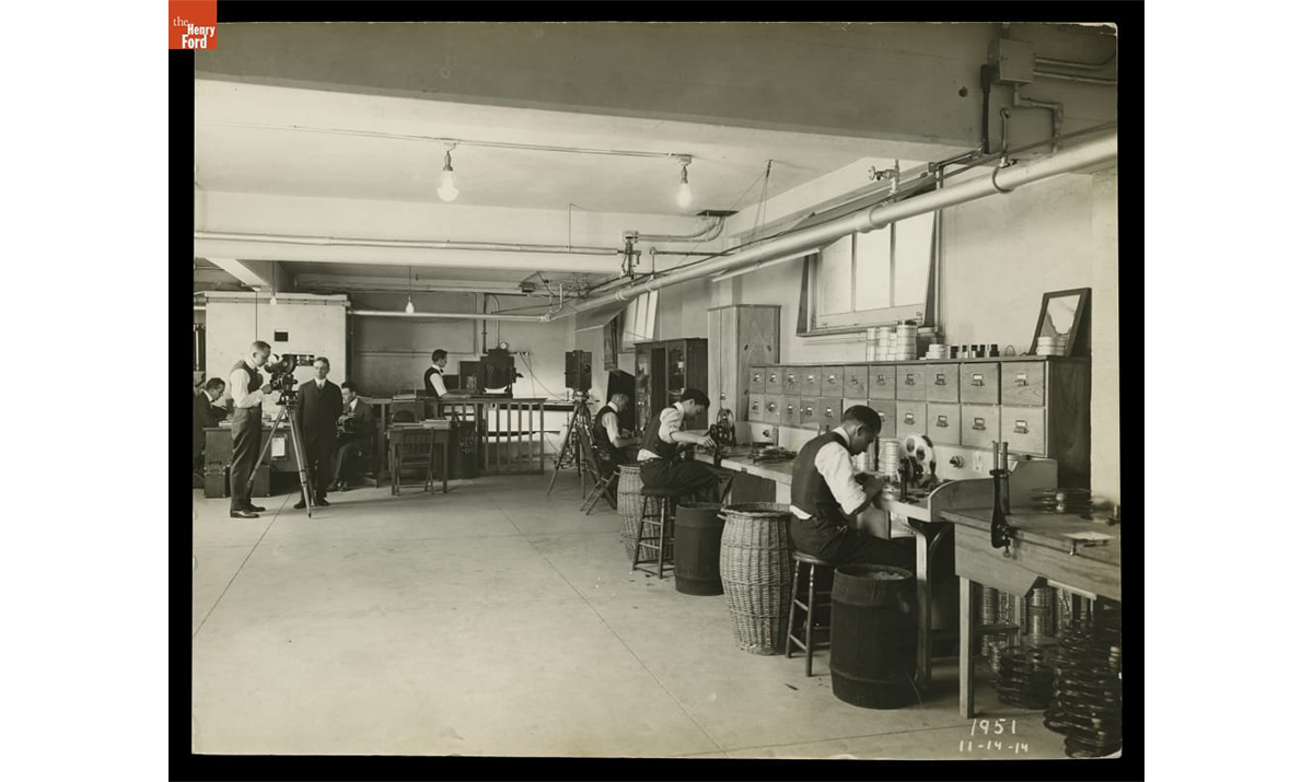 Workers at Cutting Tables and Copy Camera, Ford Photographic Department, Highland Park Plant, 1914. /THF124964