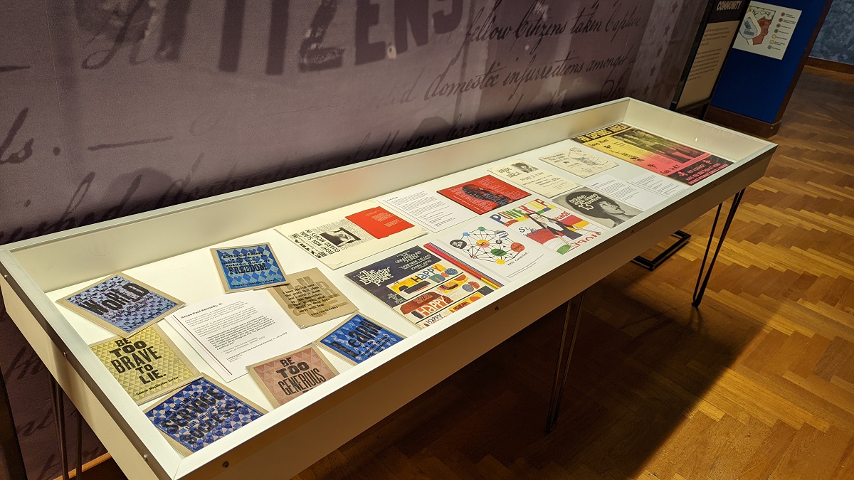 Display case containing many colorful flat paper items
