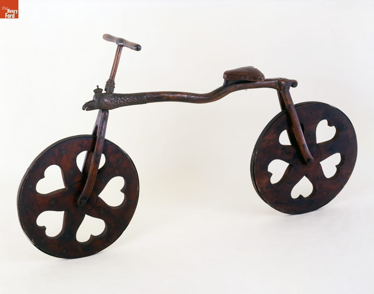 an antique bicycle with heart shaped cut-outs on its metal wheels