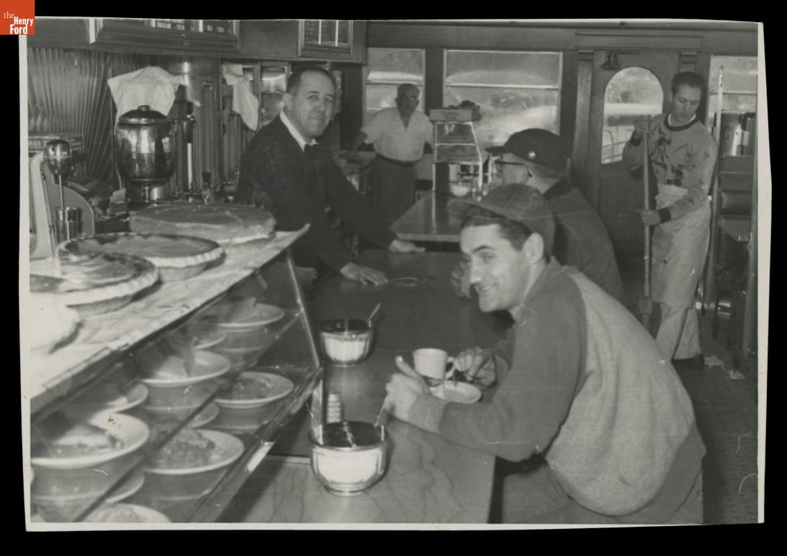 Customers eating and drinking using commercial restaurant ware at the counter inside Lamy’s Diner at its original location in Marlborough, Massachusetts.