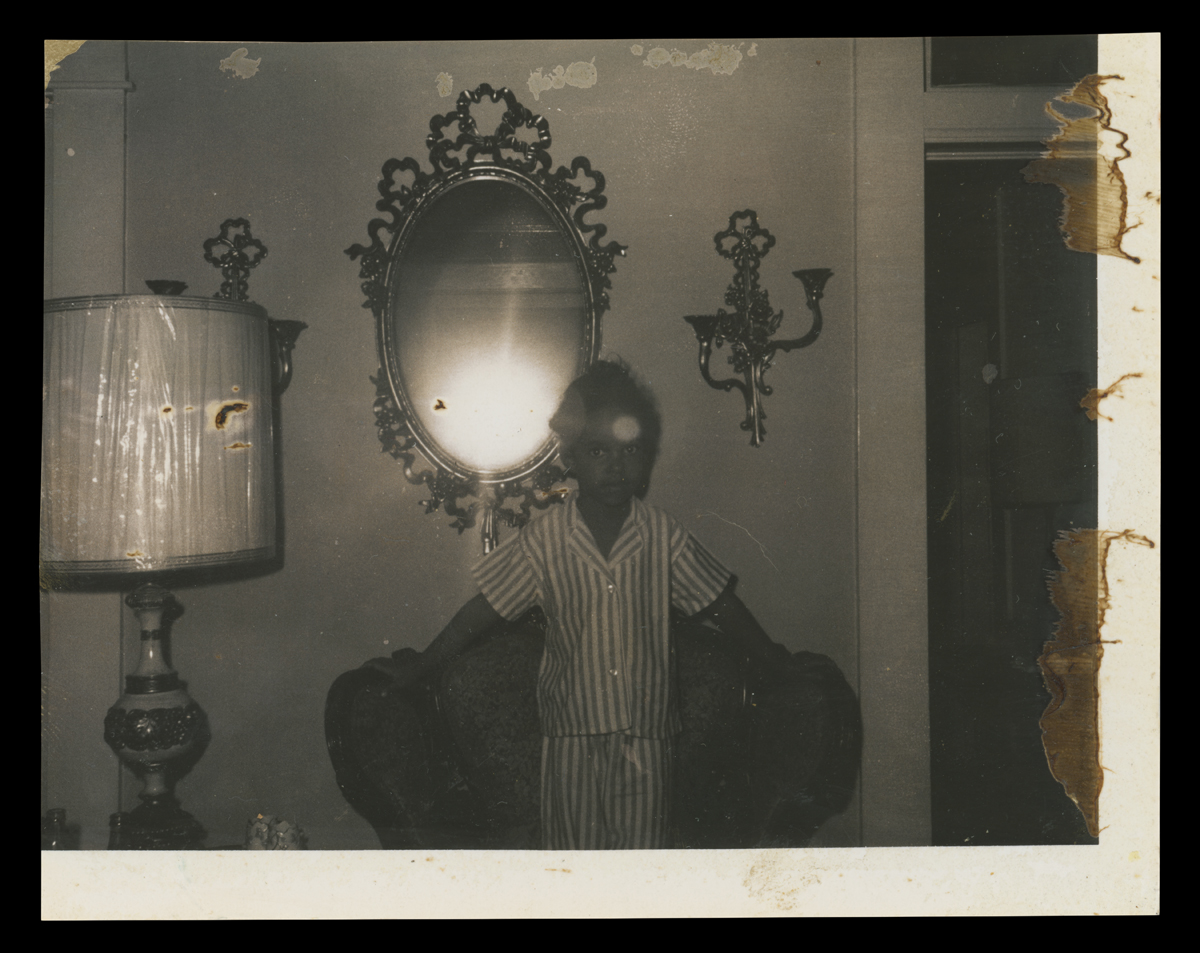 Jawana Jackson, the Jacksons’ daughter, in front of the mirror and sconces about 1965.