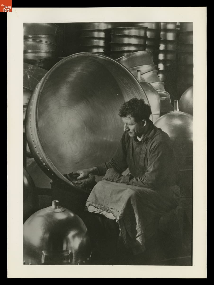 Worker Polishing a Kettle in the Chemical Laboratory. Photographed by Margaret Bourke-White for Aluminum Company of America (Alcoa), 1930-1934.